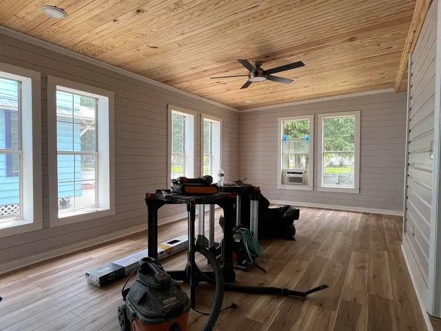 a view of a workspace with furniture and a window