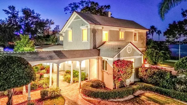a front view of a house with garden and plants