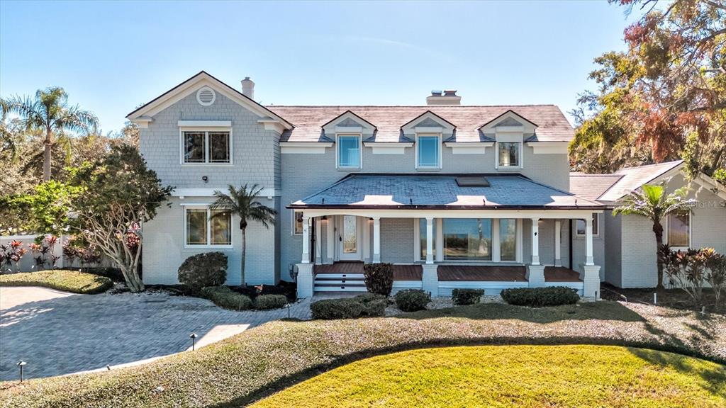 518 Riverside Drive Tarpon Springs, FL 34689 - Photo 12 of 82 a front view of house with yard outdoor seating and barbeque oven