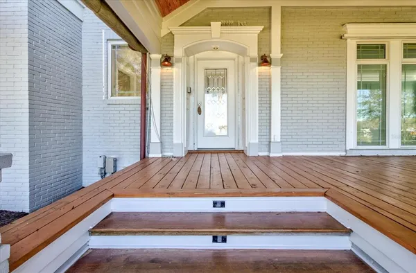 an empty room with window and wooden floor