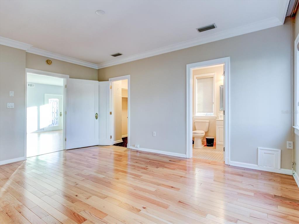 518 Riverside Drive Tarpon Springs, FL 34689 - Photo 28 of 82 a view of an empty room with wooden floor and a window