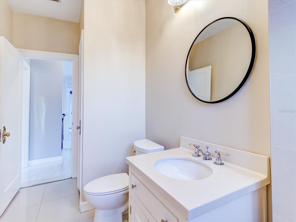 518 Riverside Drive Tarpon Springs, FL 34689 - Photo 45 of 82 a bathroom with a sink a toilet and a mirror