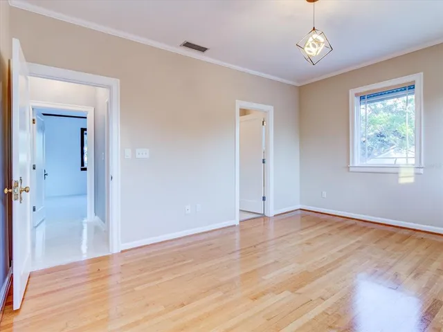 an aerial view of residential houses with outdoor space and trees