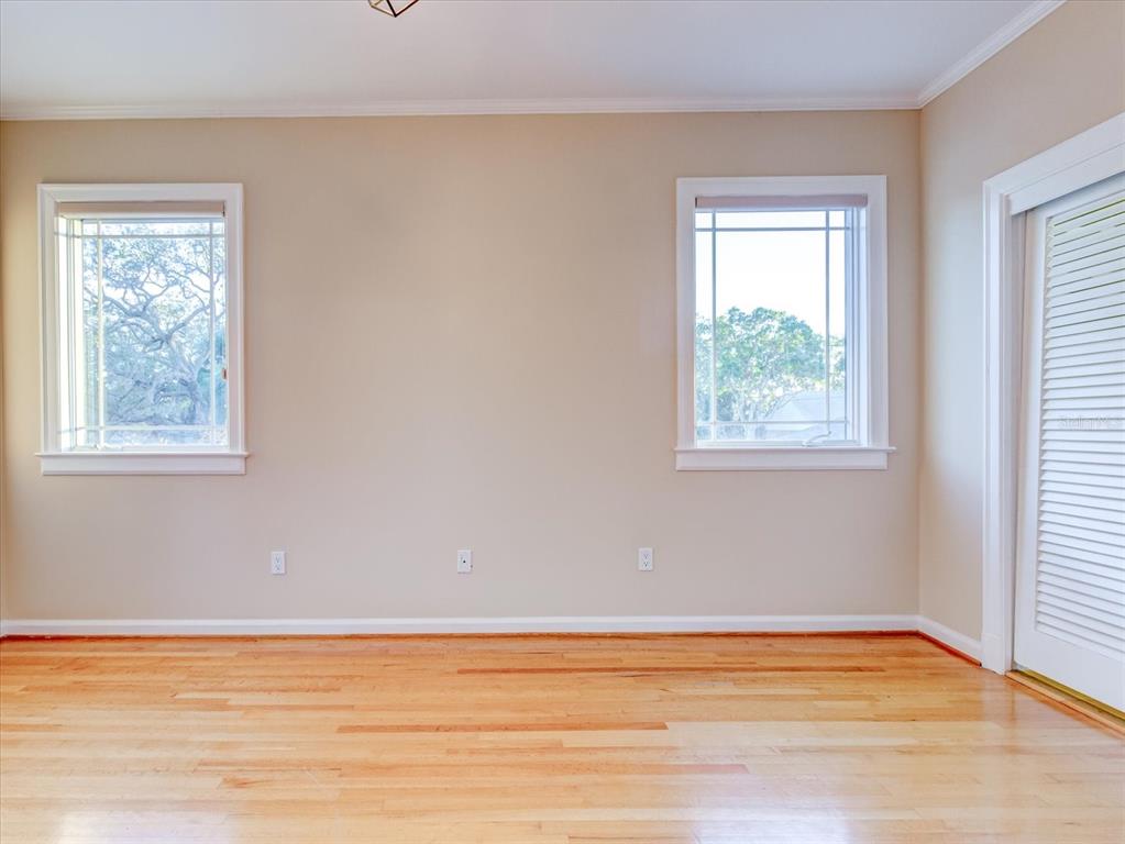 518 Riverside Drive Tarpon Springs, FL 34689 - Photo 47 of 82 a view of an empty room with wooden floor and a window