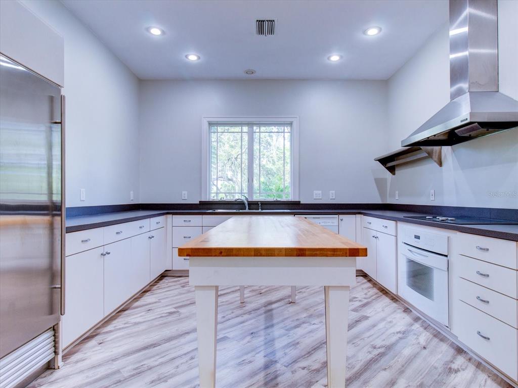 518 Riverside Drive Tarpon Springs, FL 34689 - Photo 50 of 82 a kitchen with granite countertop a sink and a stove top oven