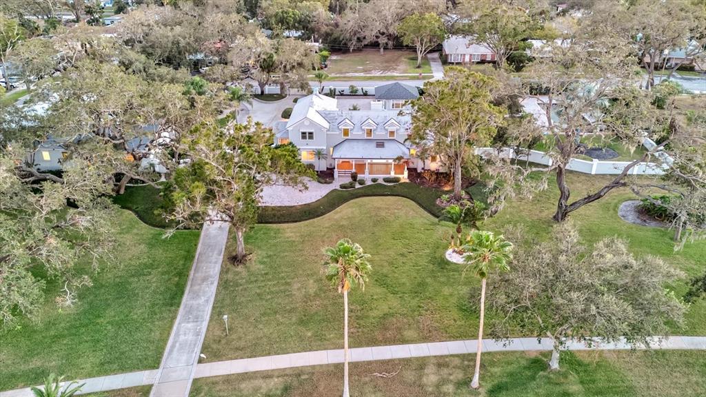 518 Riverside Drive Tarpon Springs, FL 34689 - Photo 68 of 82 a aerial view of a house with a yard basket ball court and outdoor seating