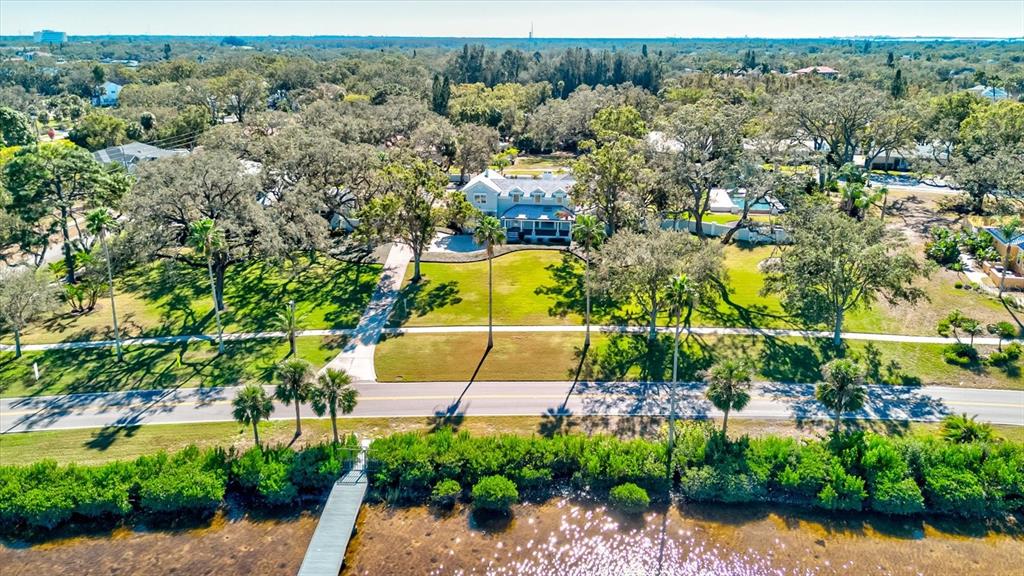 518 Riverside Drive Tarpon Springs, FL 34689 - Photo 79 of 82 an aerial view of a house with a yard and lake view