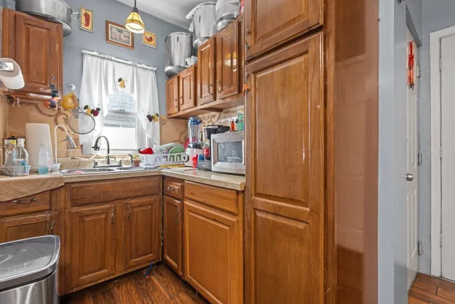 a kitchen with stainless steel appliances granite countertop cabinets and a refrigerator