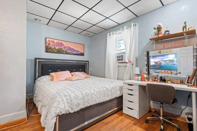 a bedroom with a bed and a desk