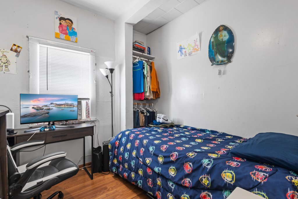 2730 South 58th Court Cicero, IL 60804 - Photo 16 of 35 a bedroom with a bed and a flat screen tv