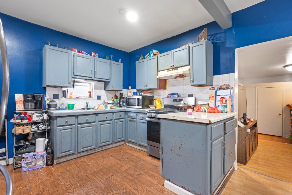 2730 South 58th Court Cicero, IL 60804 - Photo 19 of 35 a kitchen with a sink refrigerator and cabinets