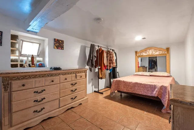 a bedroom with a bed and a dresser