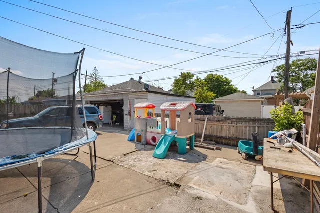 a view of a patio with a table and chairs under an umbrella
