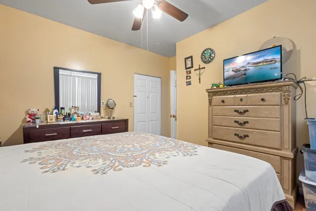 a bedroom with a bed and a flat screen tv