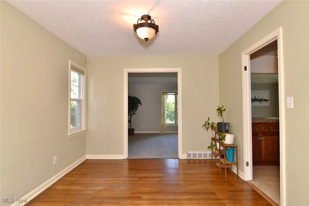 3679 Fenley Road Cleveland Heights, OH 44121 - Photo 10 of 45 Unfurnished dining area with light wood-style flooring and a textured ceiling