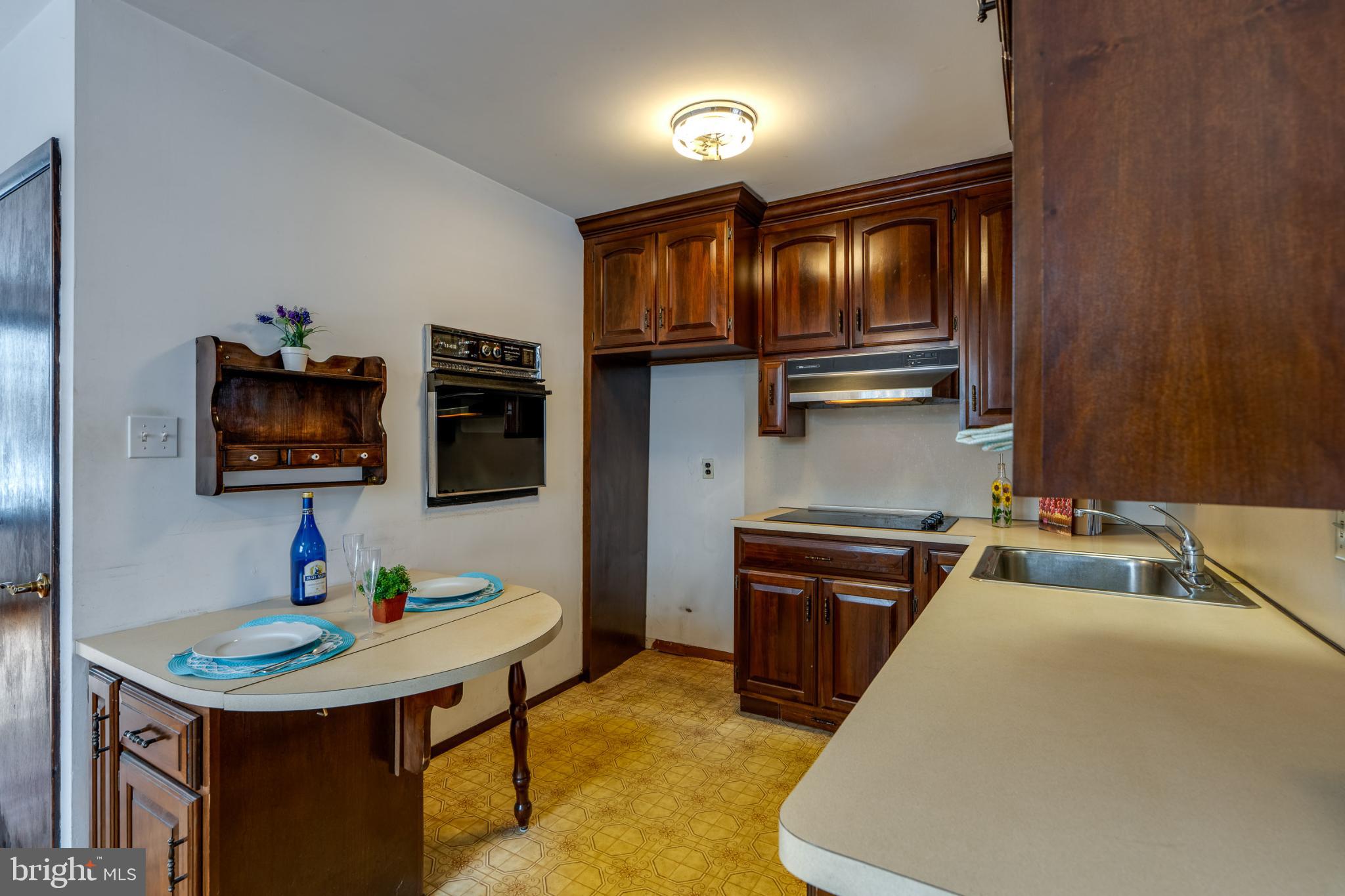 203 Alleghenyville Road Mohnton, PA 19540 - Photo 15 of 37 Cozy kitchen with rich wooden cabinetry.