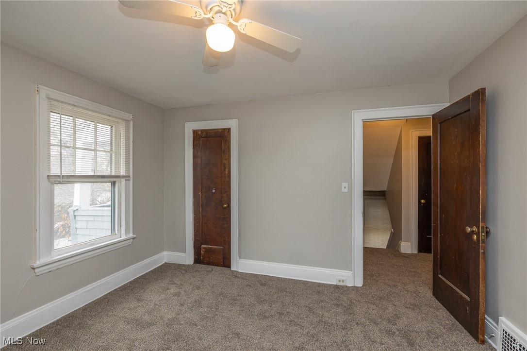 3396 Tullamore Road Cleveland, OH 44118 - Photo 16 of 23 Carpeted empty room with baseboards and a ceiling fan