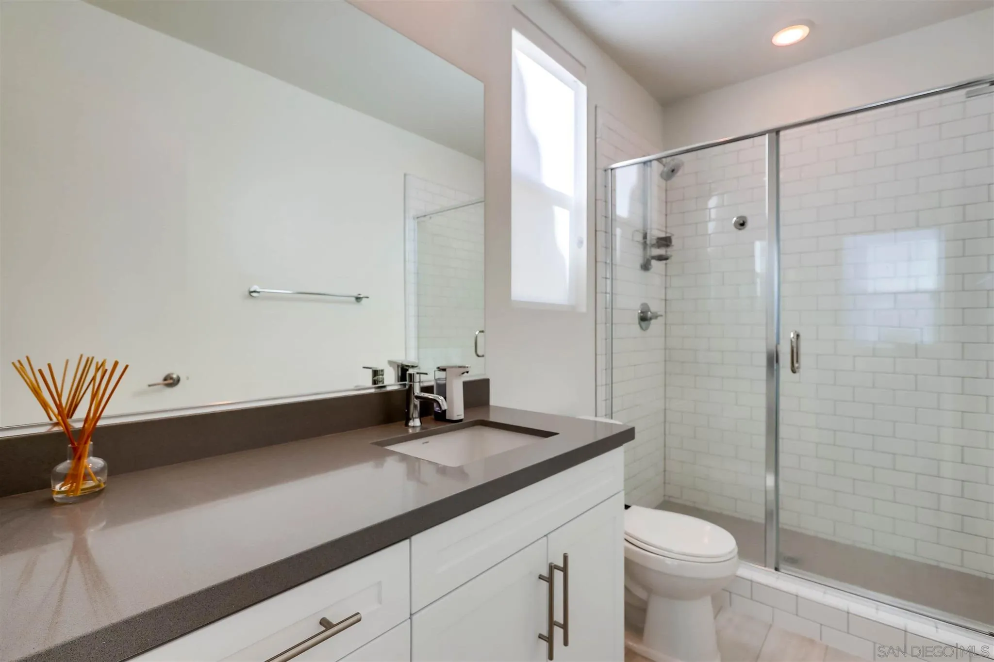 8922 Trailridge Avenue Santee, CA 92071 - Photo 13 of 31 a bathroom with a double vanity sink toilet and shower