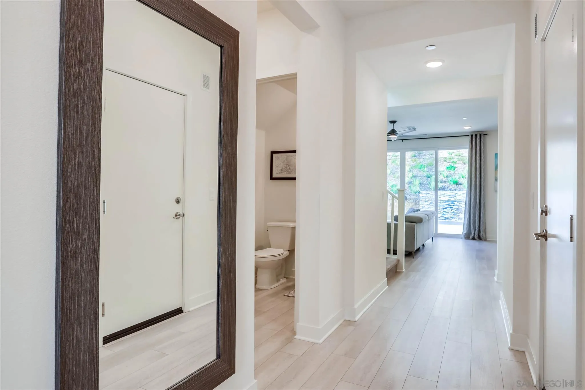 8922 Trailridge Avenue Santee, CA 92071 - Photo 2 of 31 a view of a hallway with wooden floor and a bathroom