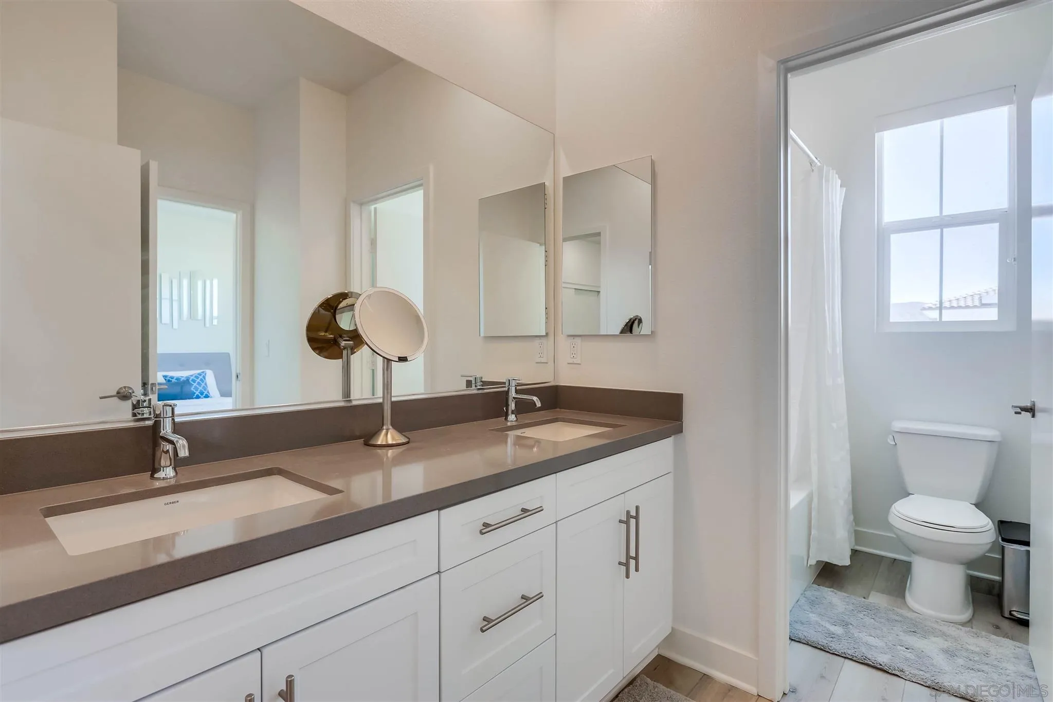 8922 Trailridge Avenue Santee, CA 92071 - Photo 23 of 31 a bathroom with a toilet a sink and mirror