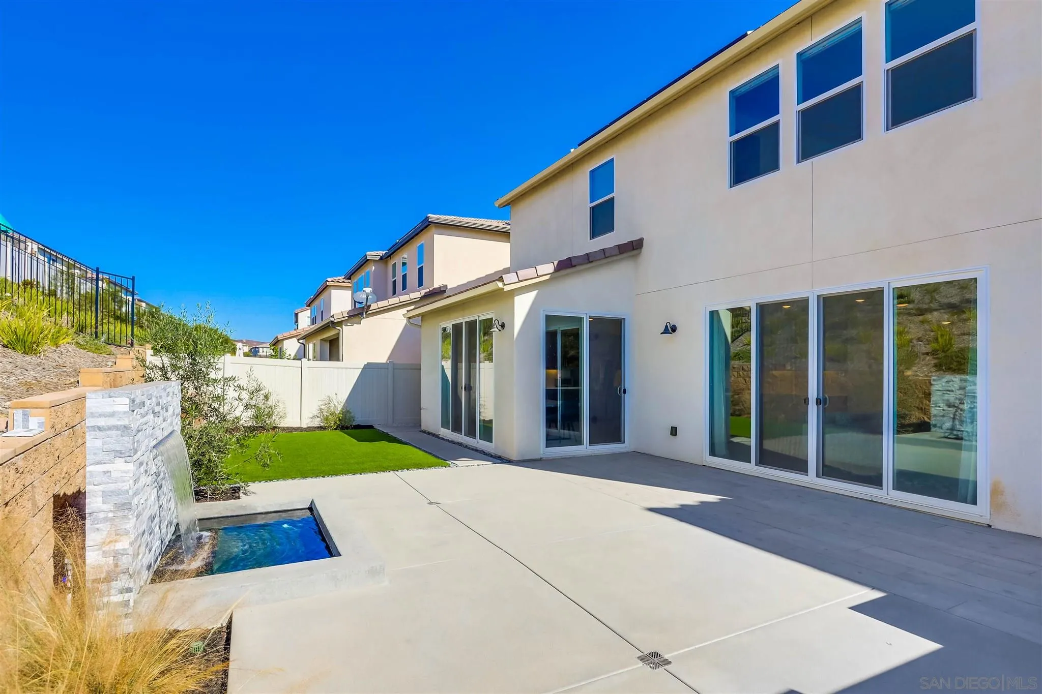 8922 Trailridge Avenue Santee, CA 92071 - Photo 28 of 31 a view of a white building with a big yard and large trees