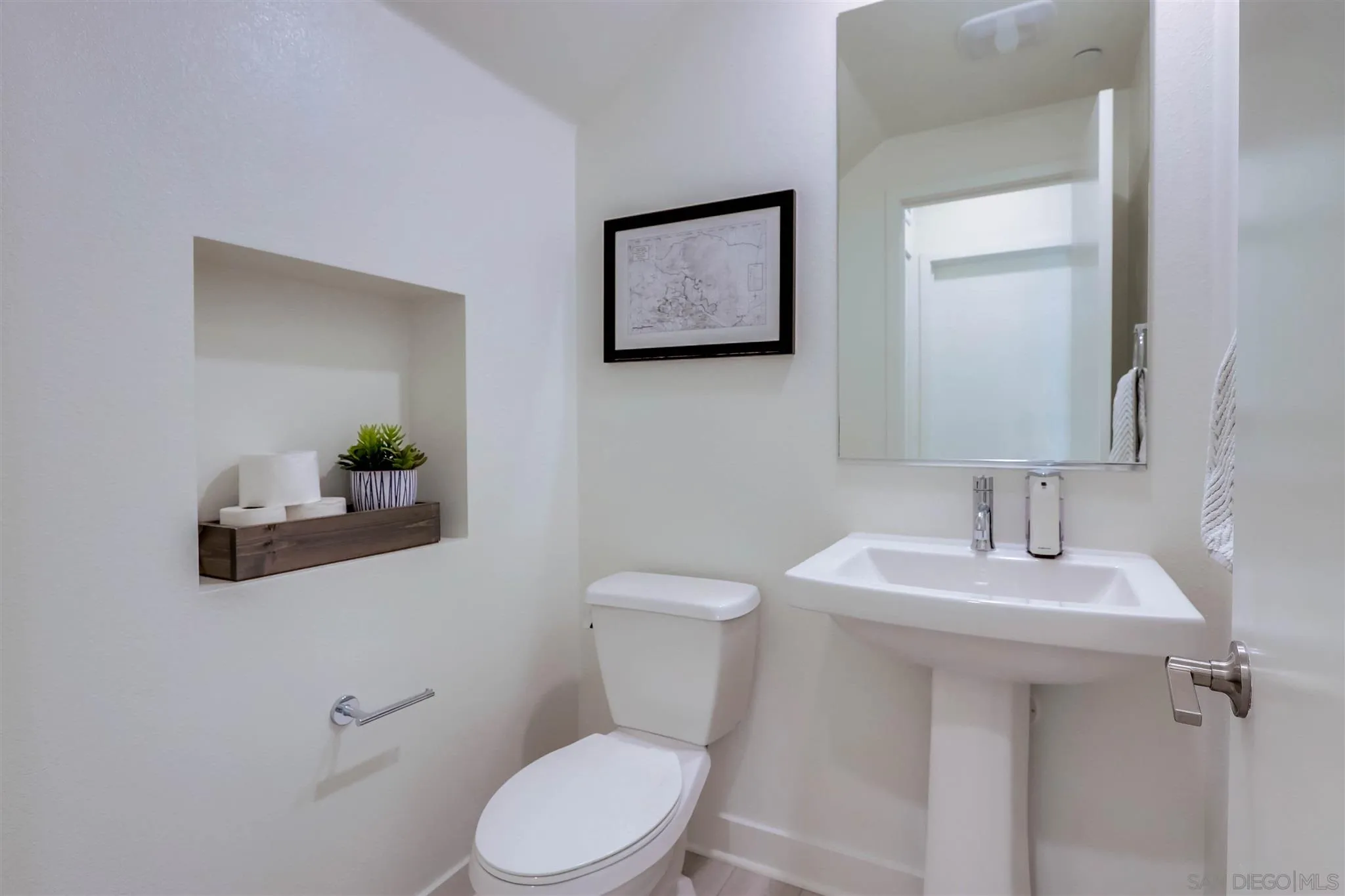 8922 Trailridge Avenue Santee, CA 92071 - Photo 3 of 31 a bathroom with a toilet a sink and mirror