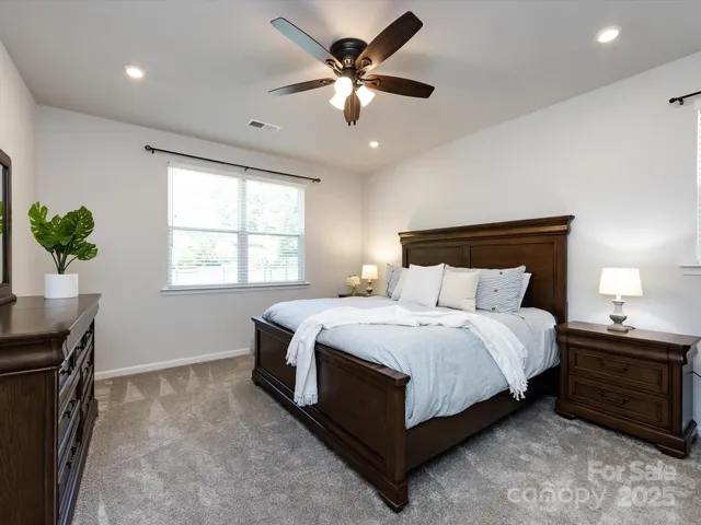a bedroom with a bed and a ceiling fan