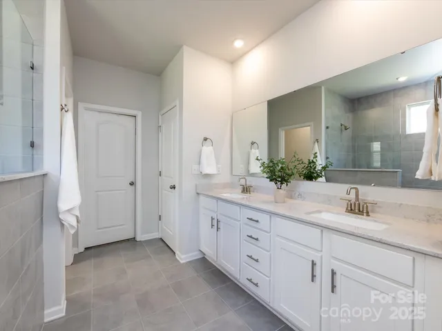 a bathroom with a tub shower and a sink