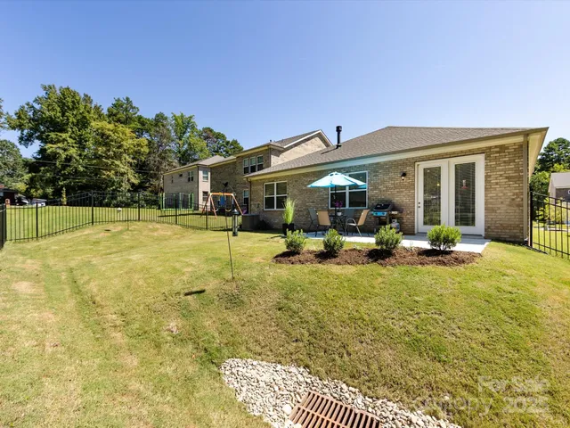 a view of a house with backyard porch and sitting area
