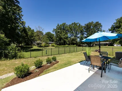 a patio with a patio table and chairs