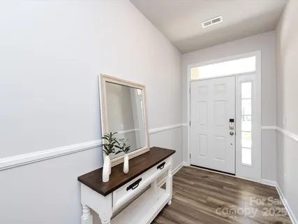 a room with wooden floor and white walls