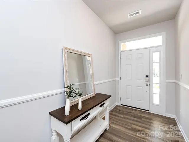 a room with wooden floor and white walls