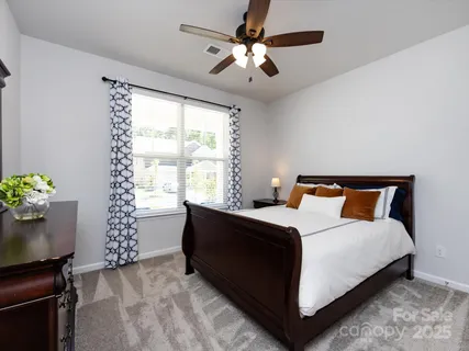 a bedroom with a bed and a night stand