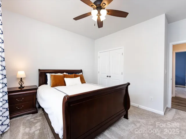 a bathroom with a granite countertop sink a toilet and a mirror