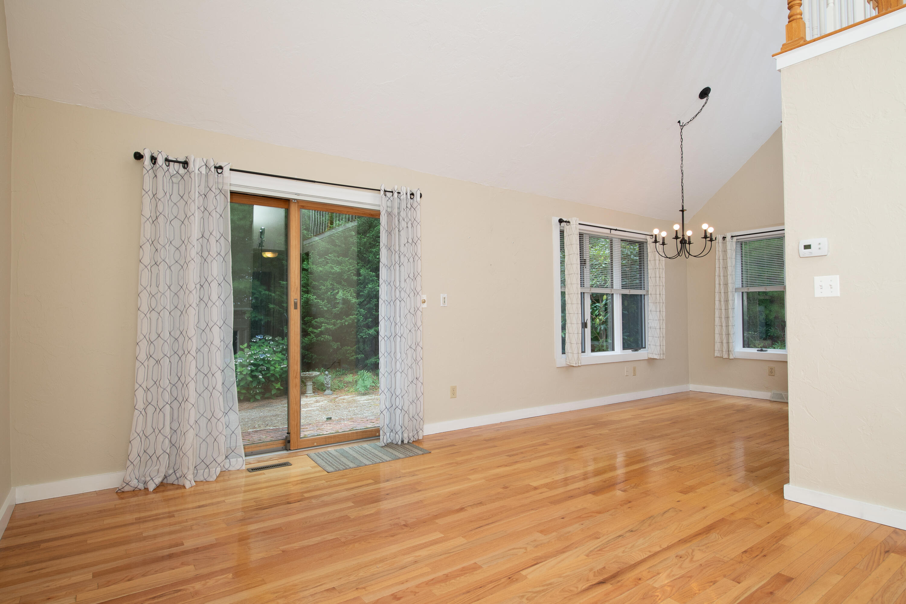 1 Shellback Way, Unit A1 Mashpee, MA 02649 - Photo 11 of 42 a view of an empty room with wooden floor and a window