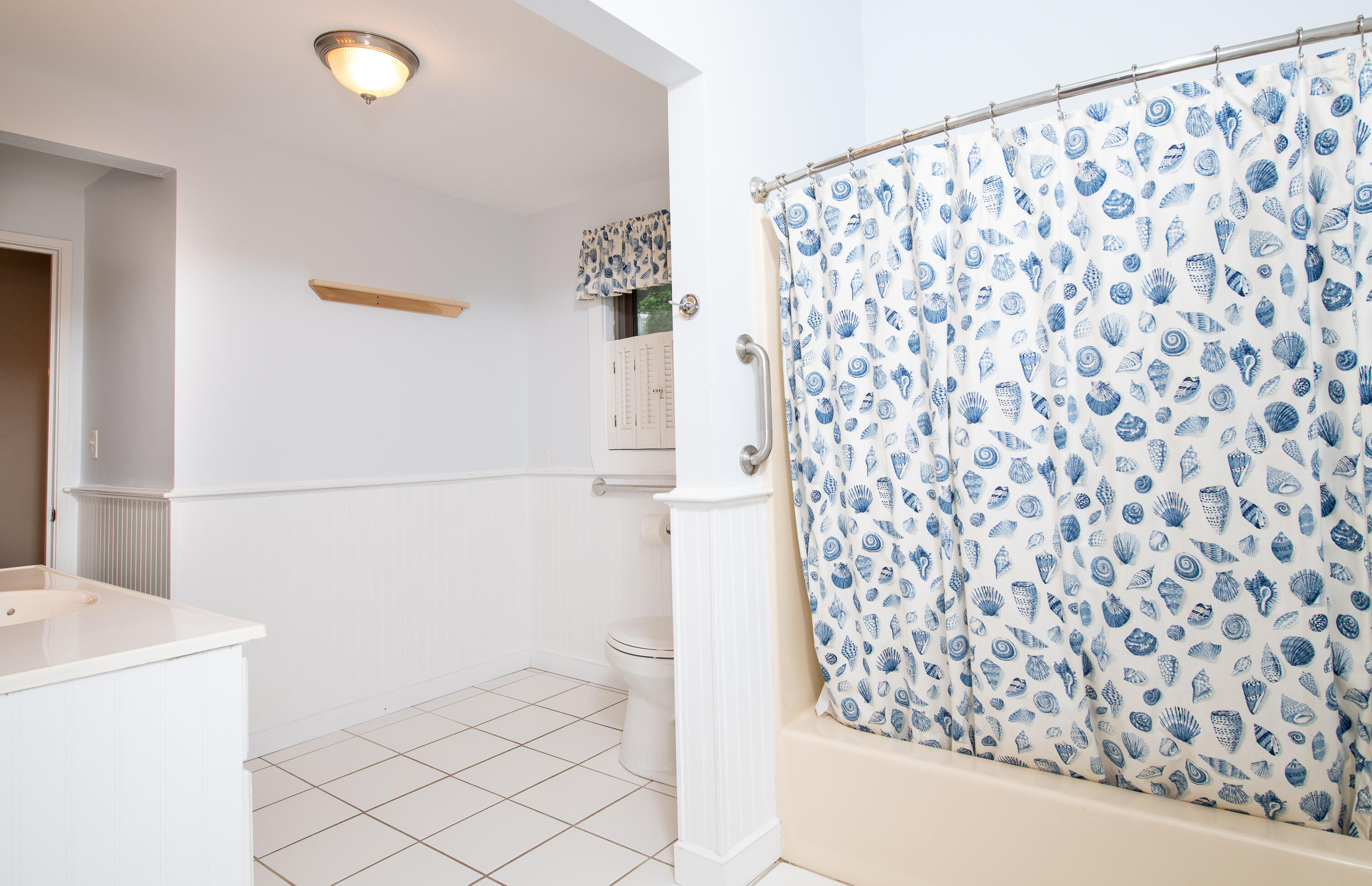1 Shellback Way, Unit A1 Mashpee, MA 02649 - Photo 21 of 42 a bathroom with a shower curtain