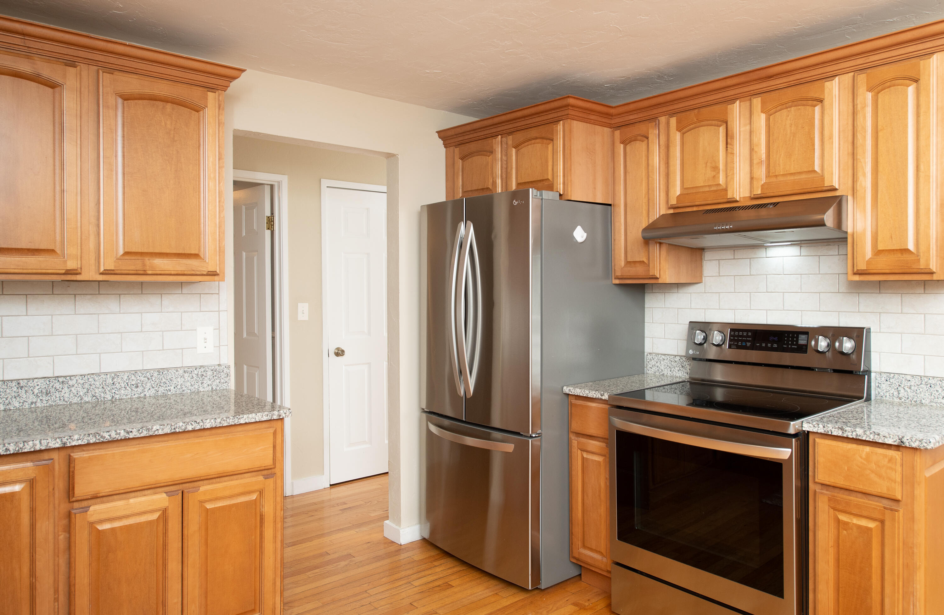 1 Shellback Way, Unit A1 Mashpee, MA 02649 - Photo 8 of 42 a kitchen with stainless steel appliances granite countertop a refrigerator stove and sink