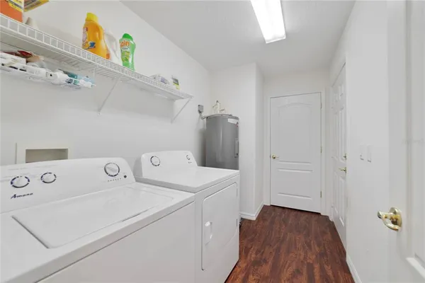a view of washer and dryer with kitchen in the background