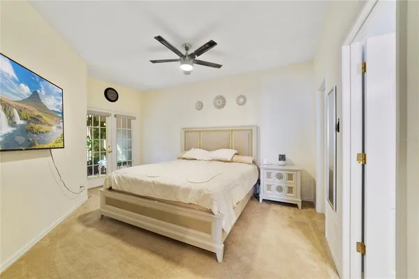 a bedroom with a bed and a painting on the wall