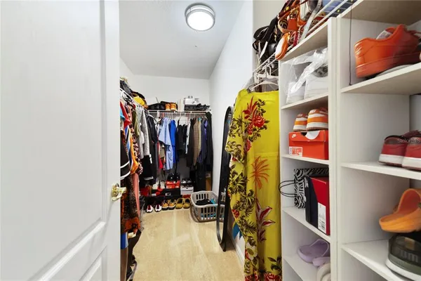 a vase of flowers sitting on a table with wooden floor