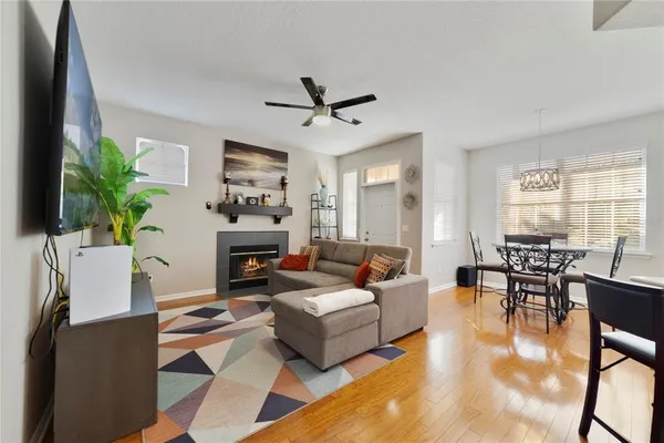 a living room with furniture a fireplace and a potted plant