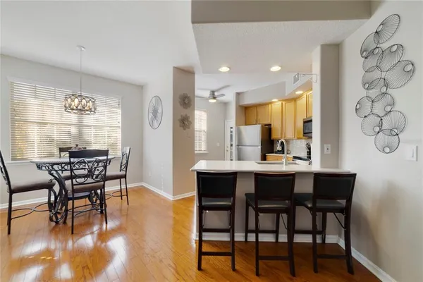 a dining room with furniture and wooden floor