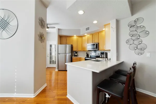 a kitchen with stainless steel appliances a sink stove refrigerator and cabinets