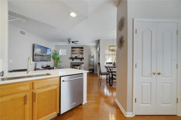 a kitchen with cabinets and wooden floor