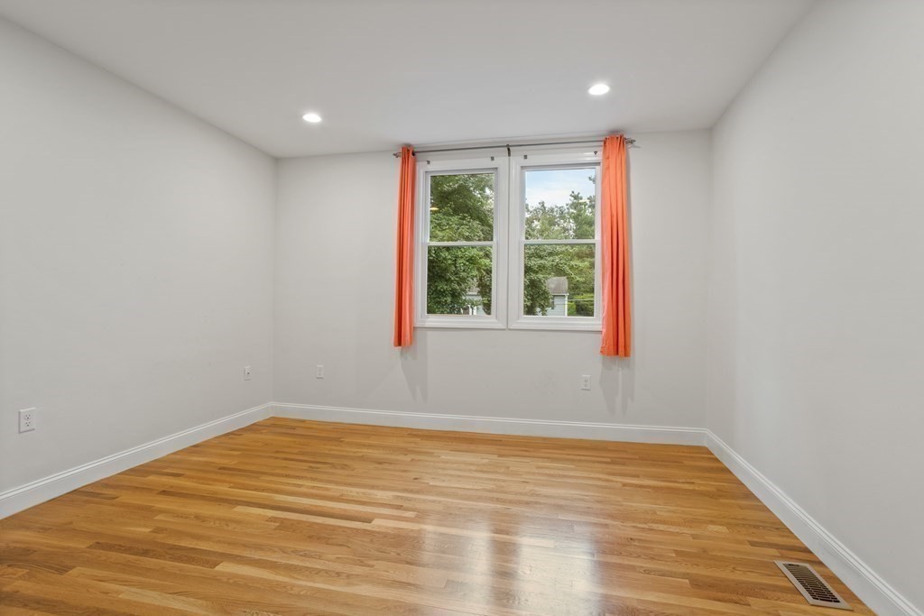26 Alta Road Sudbury, MA 01776 - Photo 20 of 37 a view of an empty room with wooden floor and a window
