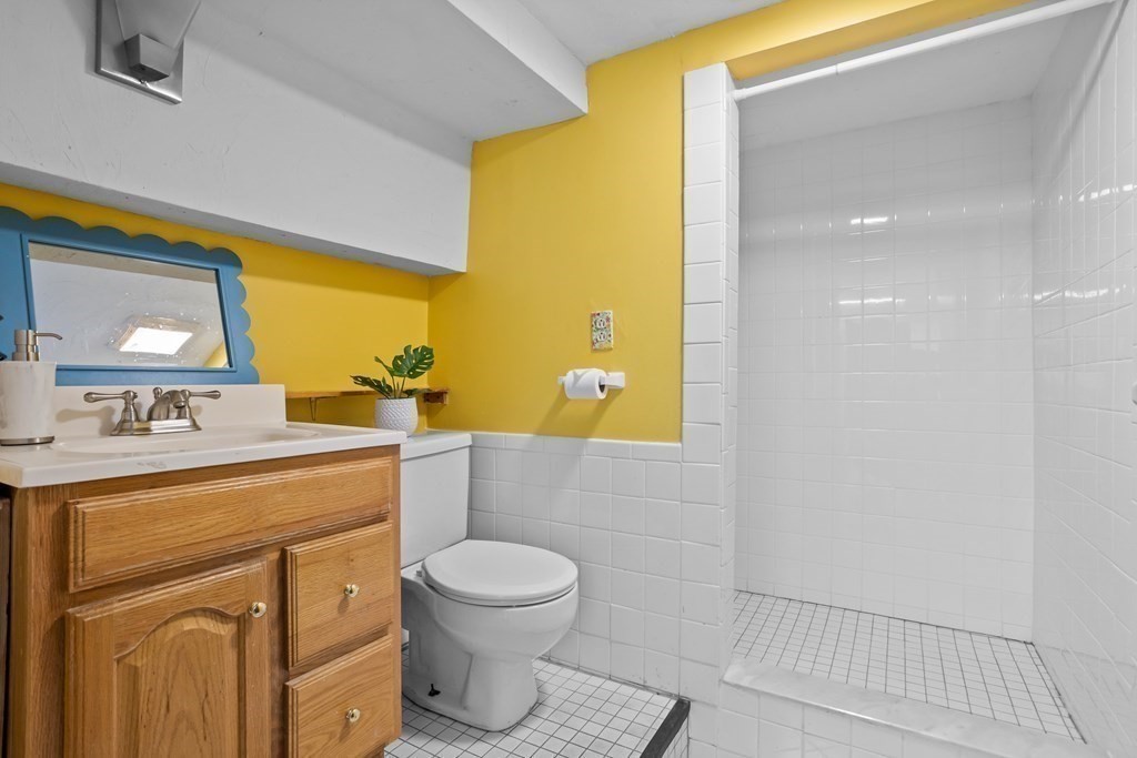26 Alta Road Sudbury, MA 01776 - Photo 27 of 37 a bathroom with a sink a toilet and mirror