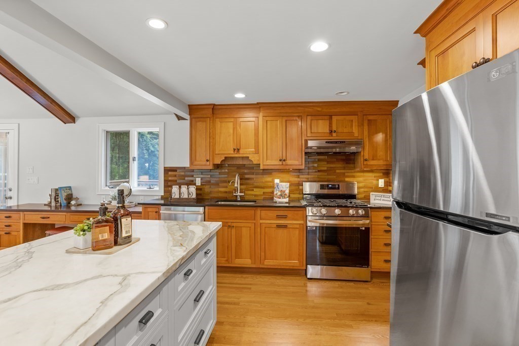 26 Alta Road Sudbury, MA 01776 - Photo 8 of 37 a kitchen with stainless steel appliances granite countertop a refrigerator a stove and a sink with wooden floors