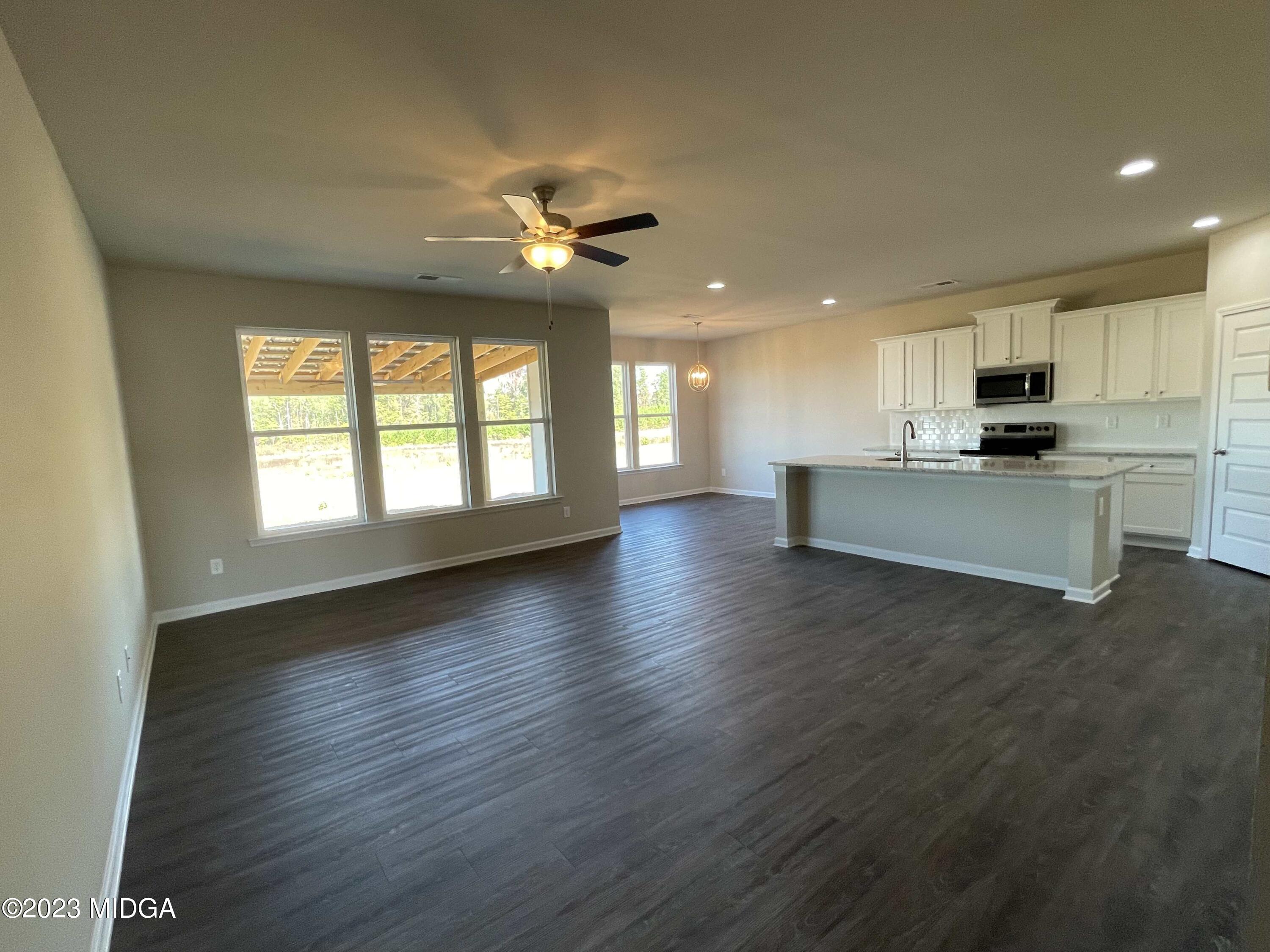 159 Sanders Road Macon, GA 31210 - Photo 12 of 40 a view of a kitchen with microwave and stove top oven