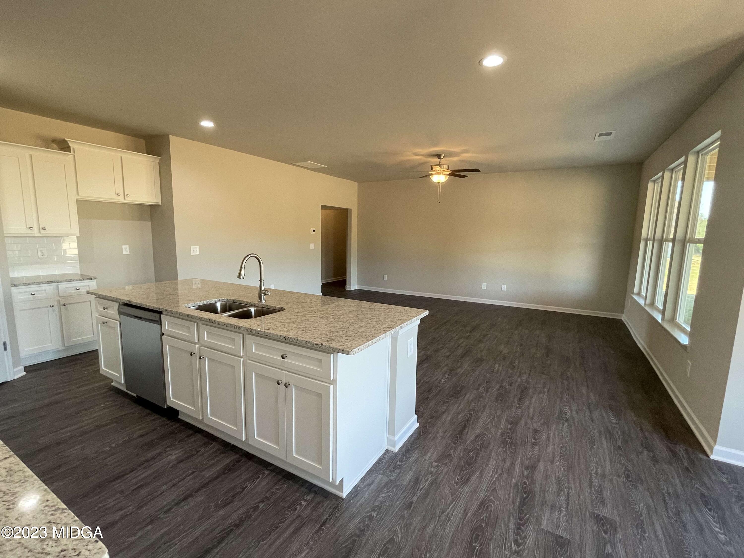 159 Sanders Road Macon, GA 31210 - Photo 14 of 40 a kitchen with wooden floors and a sink
