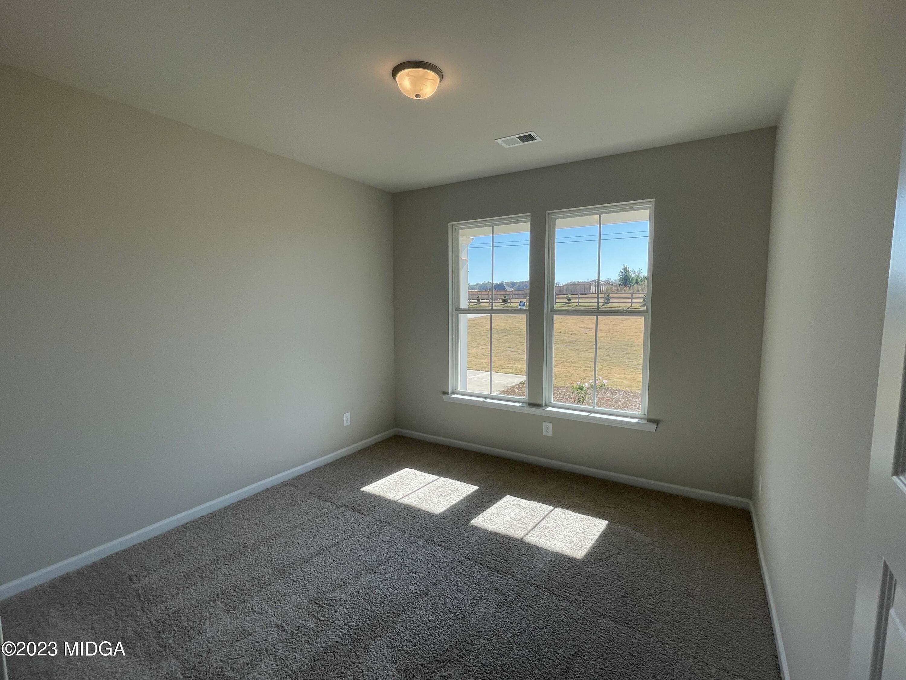 159 Sanders Road Macon, GA 31210 - Photo 18 of 40 an empty room with a window